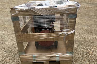 Plastic-wrapped see-through wooden crate